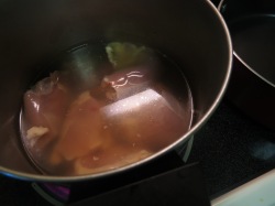 Chicken in broth, set to boil.